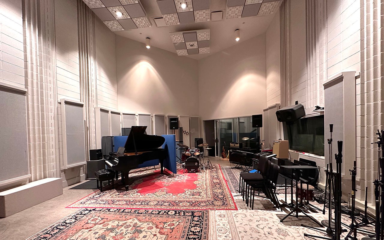 ccm-corbett-audio-production-center-2024-01.jpg A recording space within the Ralph J. Corbett Audio Production Center outfitted with a piano and drum kit