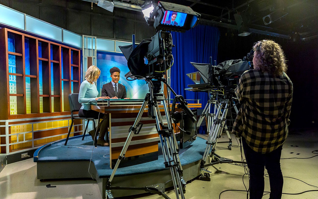 ccm-broadcast-news-2024-01.jpg Two students film a broadcast in the Bartlett Television Center