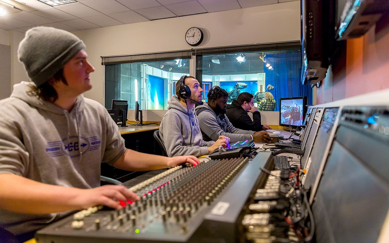 ccm-broadcast-news-2024-02.jpg Four Media Production students work the control panel in the Bartlett Television Control Room