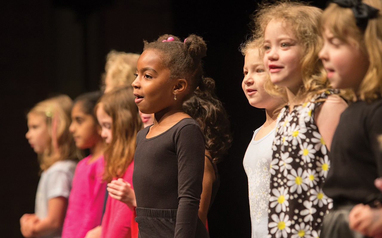 Primary school-aged students sing on stage during the CCM Prep’s Year End Festival