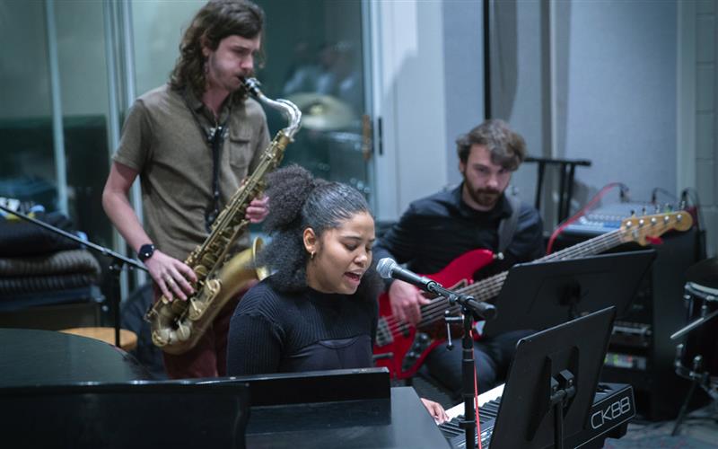 Students play instruments in a rock band. 